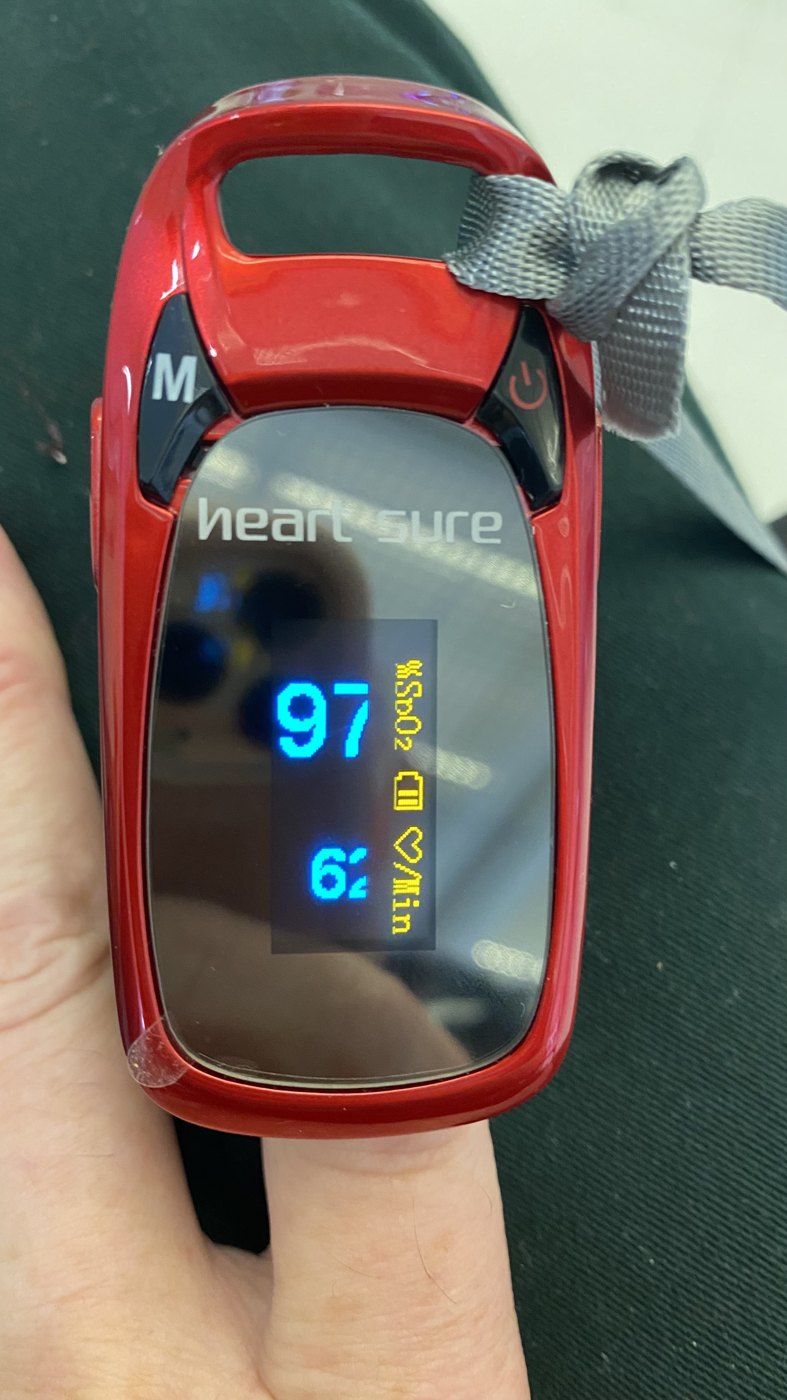 Consumer fingertip oximeter showing SpO2 97 percent and pulse around 62.